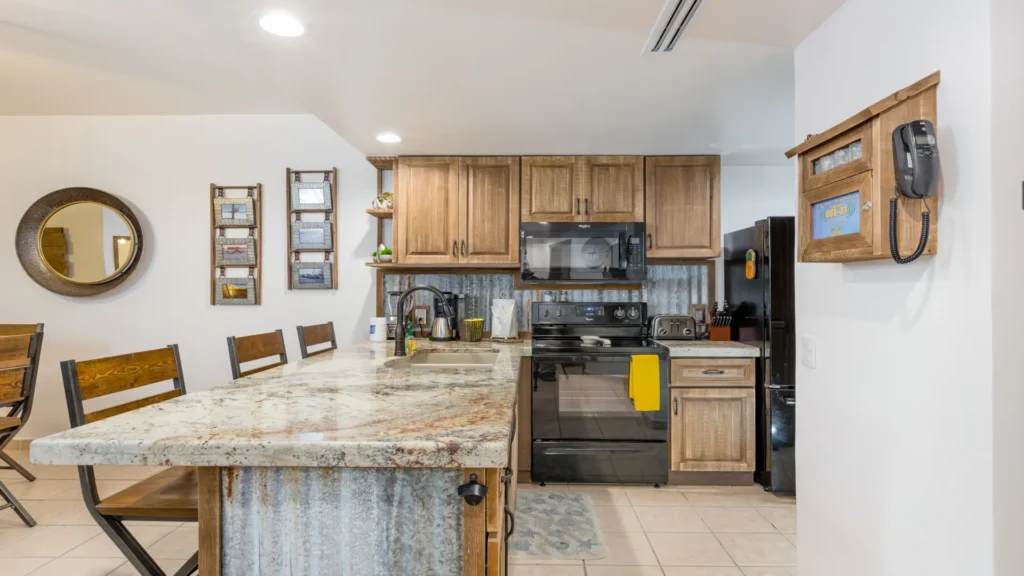 Renovated kitchen with rustic coastal charm and modern appliances in beachfront condo