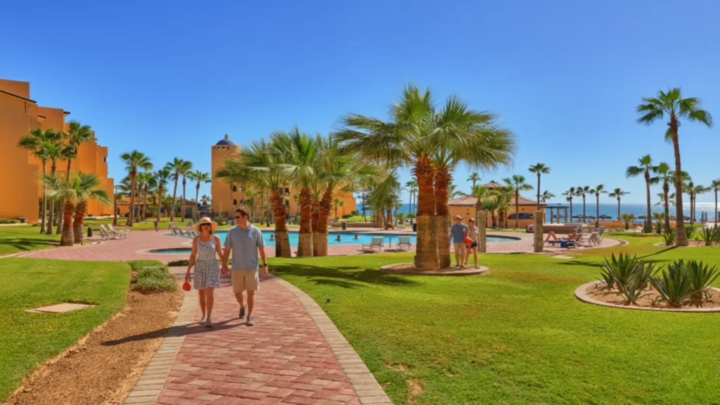 Lush lawns and palm trees with ocean views throughout Princesa Resort on Sandy Beach