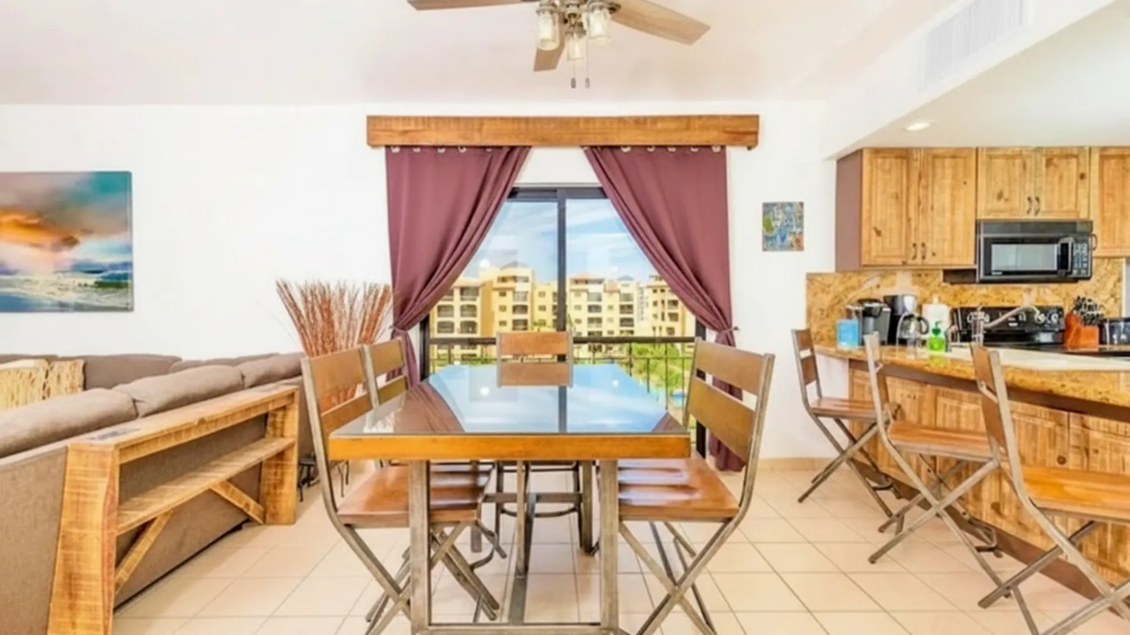 Dining table positioned perfectly to capture the vast blue ocean views through the window.