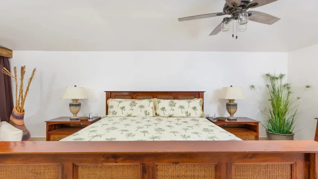 Upstairs master bedroom featuring a king size bed in beachfront penthouse