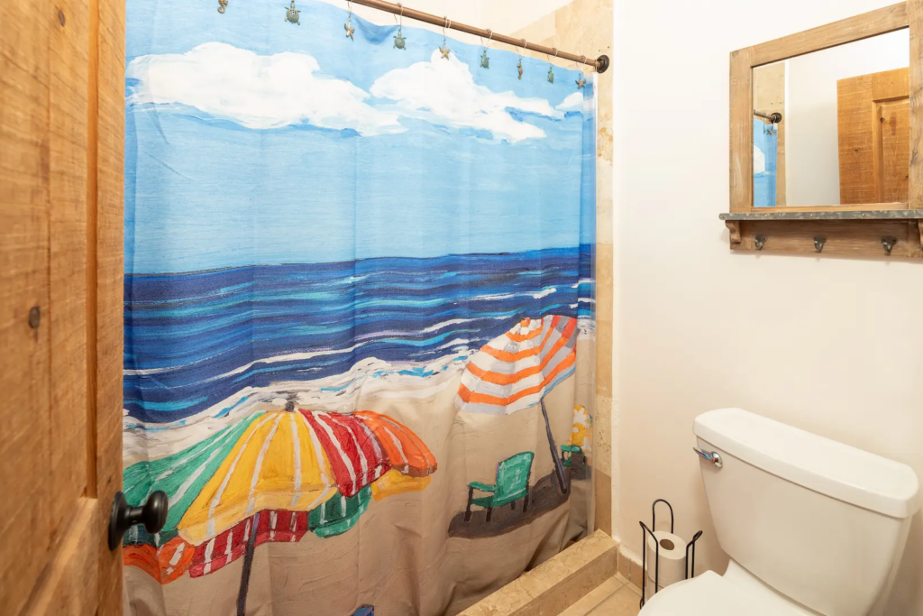 Spacious walk-in shower with high-quality tile and glass accents.