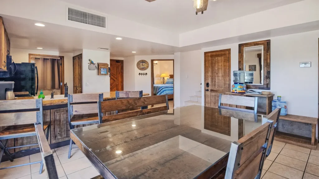 Large dining table next to open kitchen in beachfront penthouse