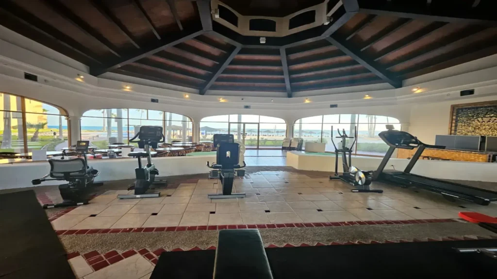 Resort fitness center with workout equipment and ocean views