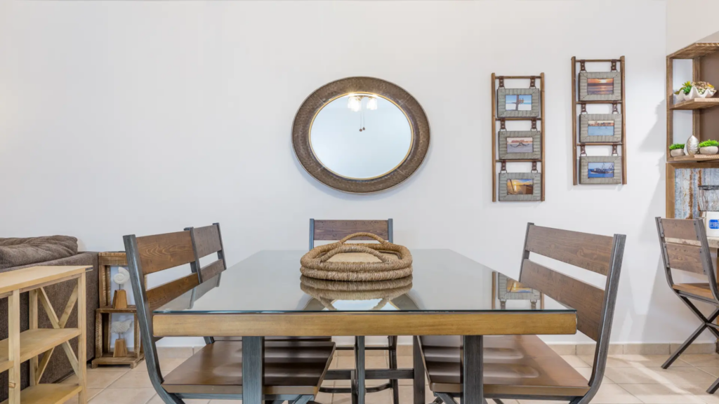 Glass-top dining table with upholstered chairs