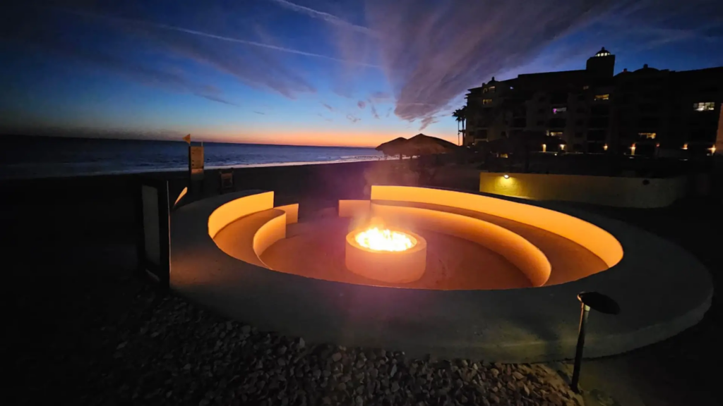 Contemporary circular fire feature glowing at twilight