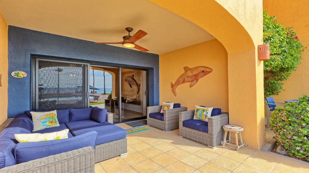 Large beachfront ground floor patio with outdoor seating overlooking Sandy Beach