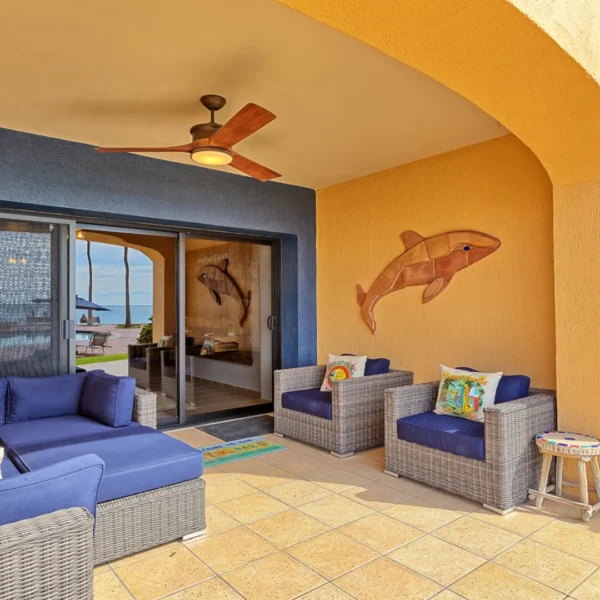 Large beachfront ground floor patio with outdoor seating overlooking Sandy Beach