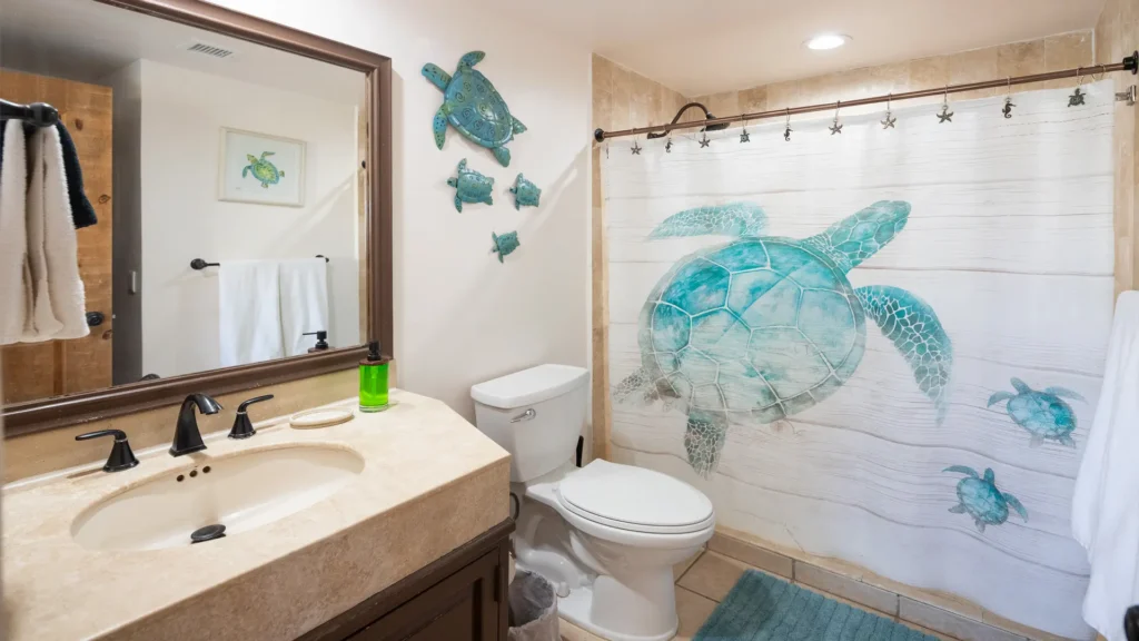 Bathroom with coastal turtle decor in the E501 2BD two-story penthouse at Princesa Sandy Beach, Rocky Point.