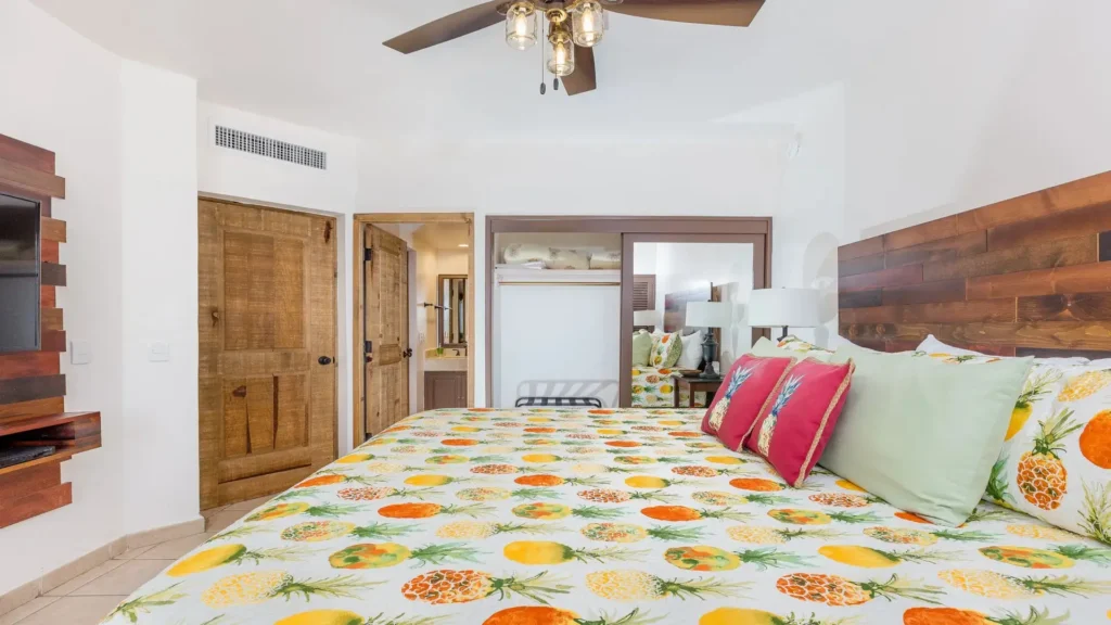 Oceanfront pineapple-themed bedroom with comfortable king bed, tropical decor, and furnishings inside the Princesa E501 2BD two-story penthouse.