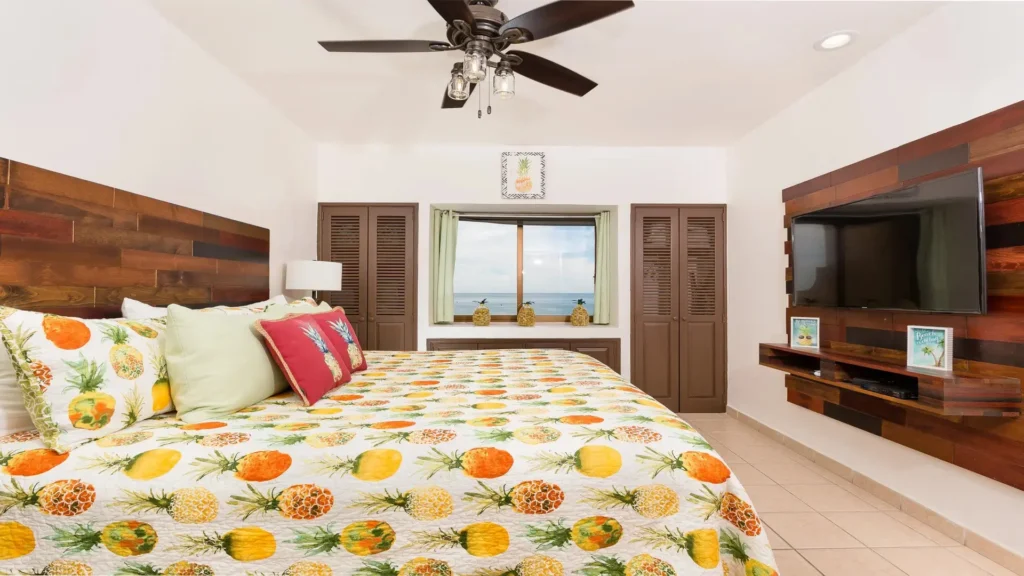Pineapple-themed bedroom with king bed and ocean view inside the Princesa E501 penthouse in Rocky Point.