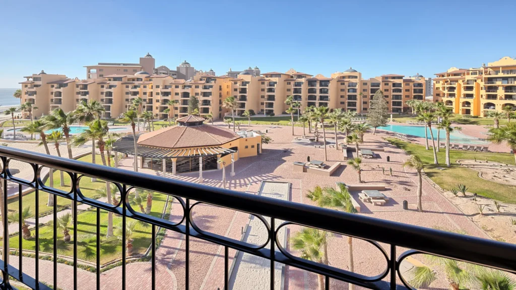 Princesa resort courtyard and swimming pools viewed from the private balcony of the E501 2BD two-story penthouse in Rocky Point.