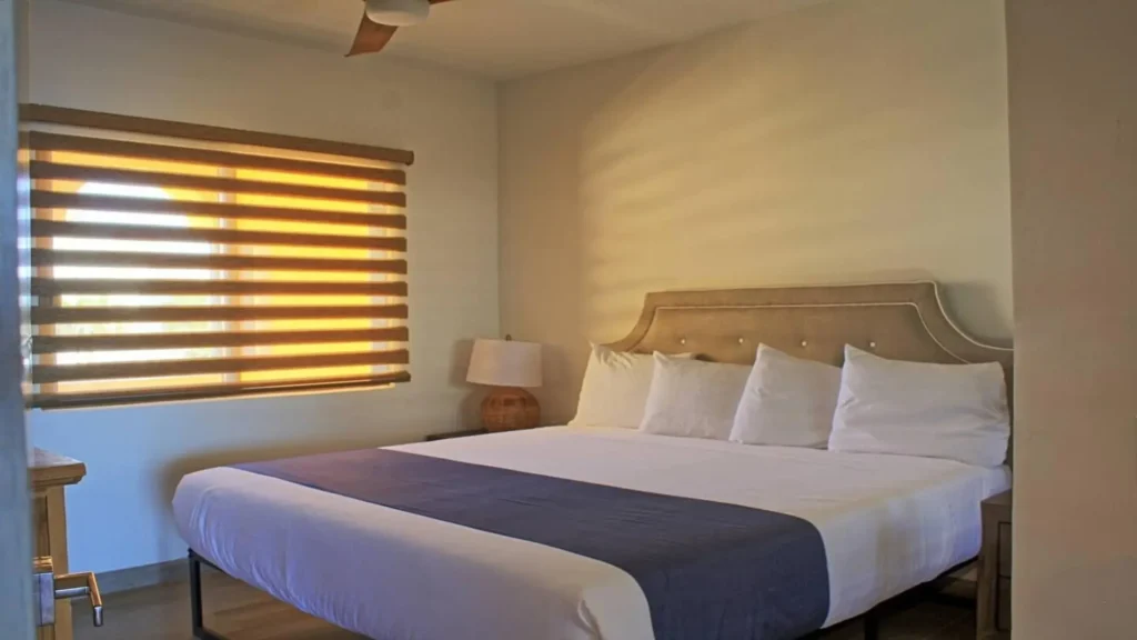 The spacious second bedroom in D503 boasts a comfortable king bed, offering a relaxing and ample sleeping area at Rocky Point Sandy Beach.