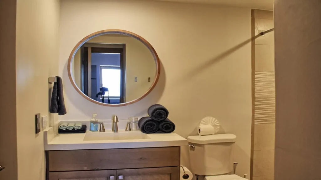 Modern vanity in the guest bathroom of 3BD D503, featuring a sleek countertop and mirror at Rocky Point Sandy Beach.
