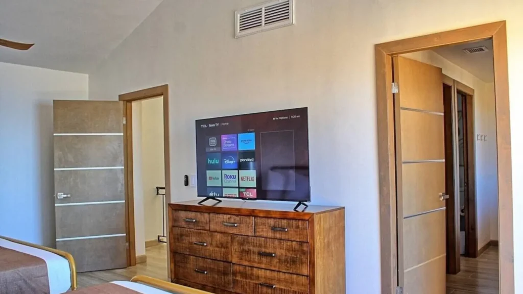 Comfortable bedroom in 3BD D503 featuring a large flat-screen TV for entertainment and relaxation at Rocky Point Sandy Beach.