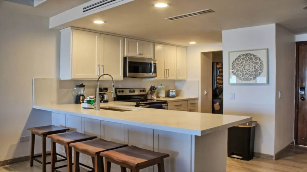 Large kitchen island in 3BD D503 with bar stool seating, perfect for casual breakfasts or entertaining guests.