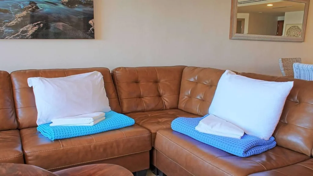 View of the living room lounge seating, highlighting the cozy sofa and overall spaciousness of 3BD D503 at Rocky Point Sandy Beach.