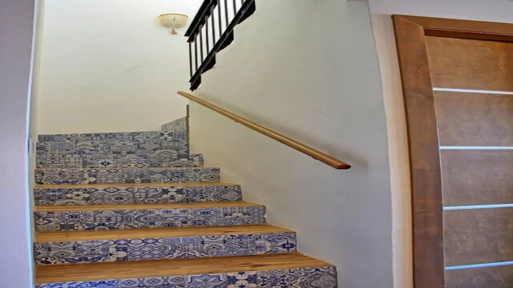 Modern architectural staircase in the interior of 3BD D503, connecting floors with a sleek design at Rocky Point Sandy Beach.