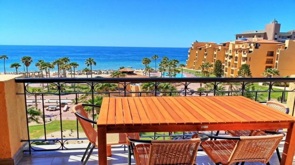 Morning al fresco dining on the balcony of 3BD D503 at Rocky Point, offering a stunning view of Sandy Beach for a fresh start.