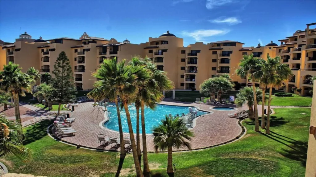 The resort's stunning pool area with sun loungers, visible from 3BD D503, offering a refreshing view of Rocky Point Sandy Beach.