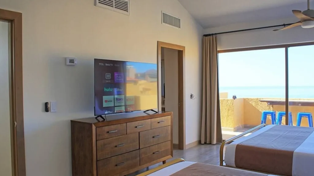 Second floor bedroom at Princesa Resort in 3BD D503, offering a great view of the Rocky Point Sandy Beach coastline for a stunning seaside awakening.