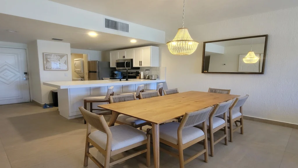 Spacious dining area with an extended table that comfortably seats everyone—perfect for gathering and sharing meals in a relaxed, modern boho setting.
