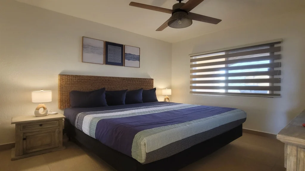Guest bedroom featuring a comfortable king bed, perfect for unwinding after a day at the beach or pool.